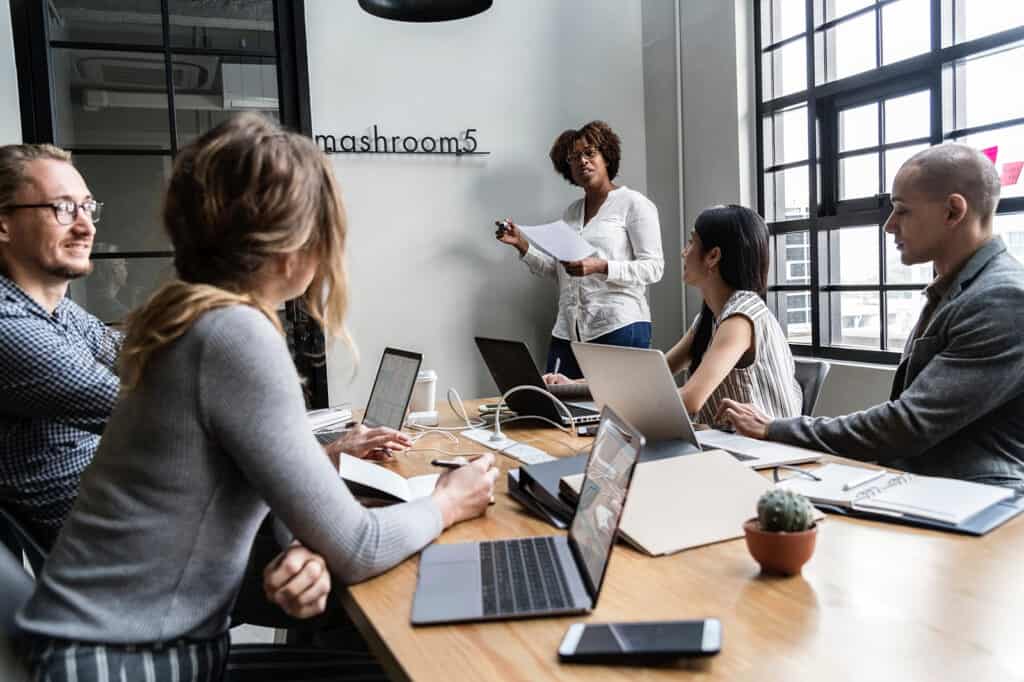Business team gathering around a table to discuss reporting